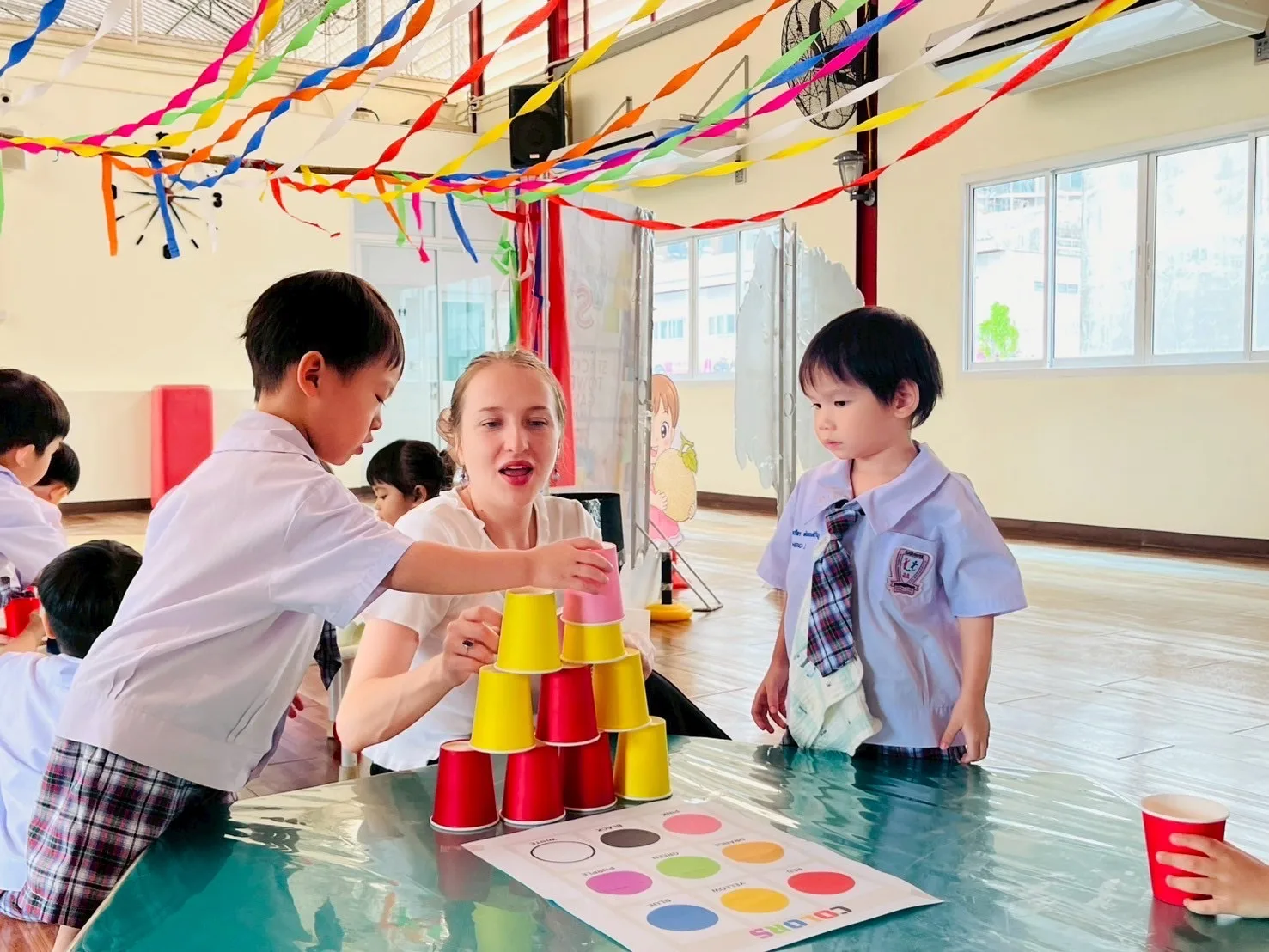 Children stacking cups in a Creative English activity