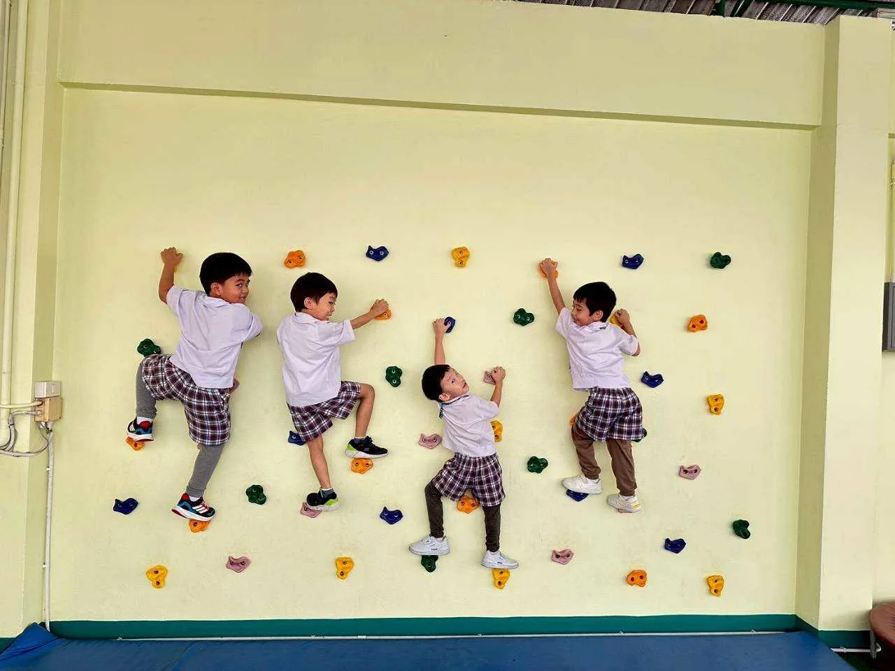 Children practising on the outdoor climbing wall
