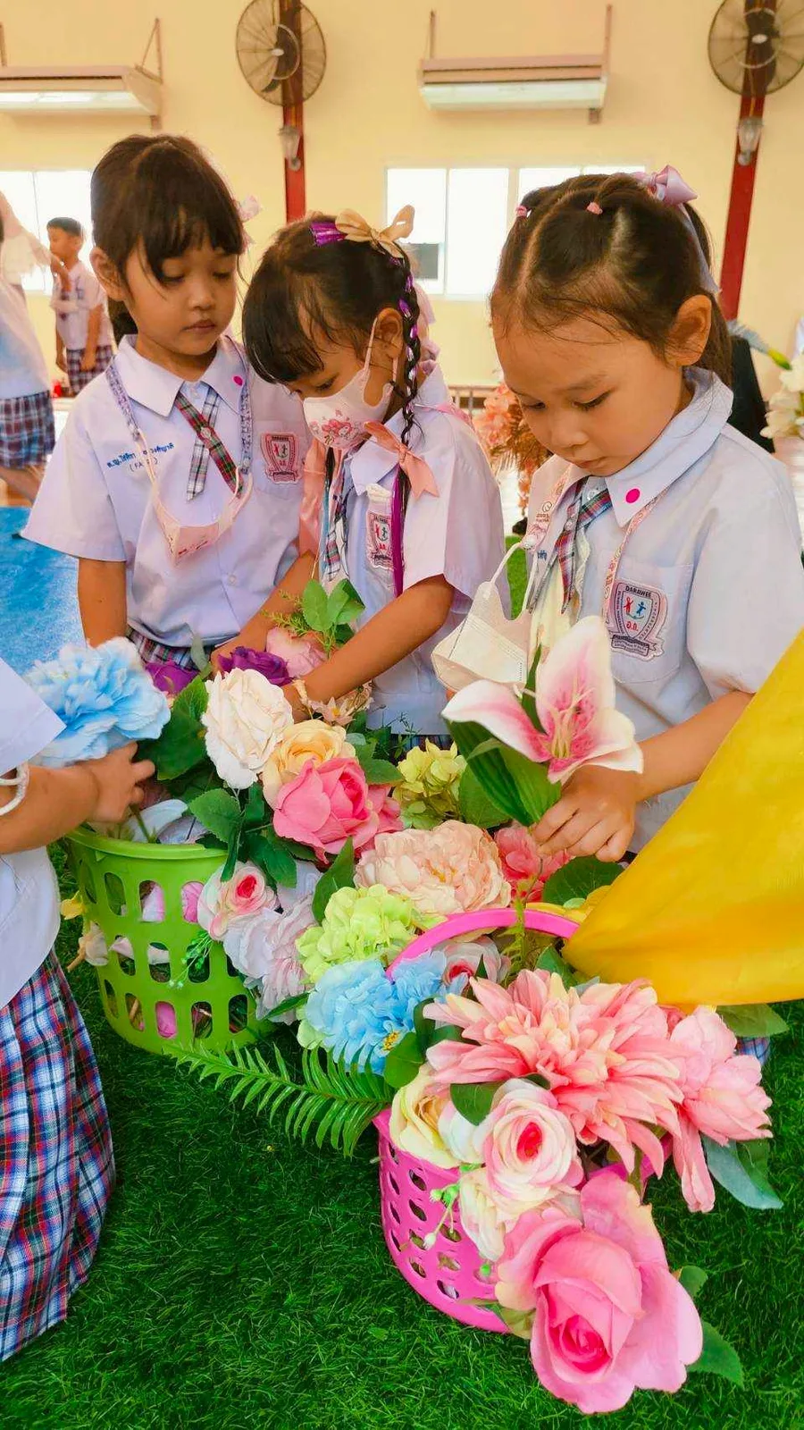Children arranging a flower craft in a basket
