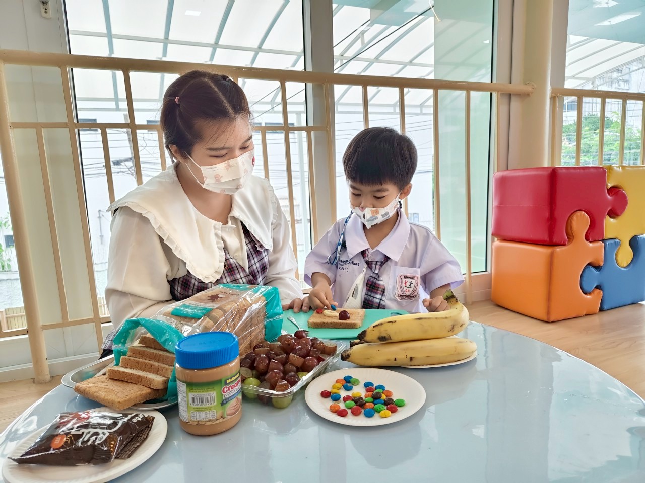 Teacher and child in taste and food activity