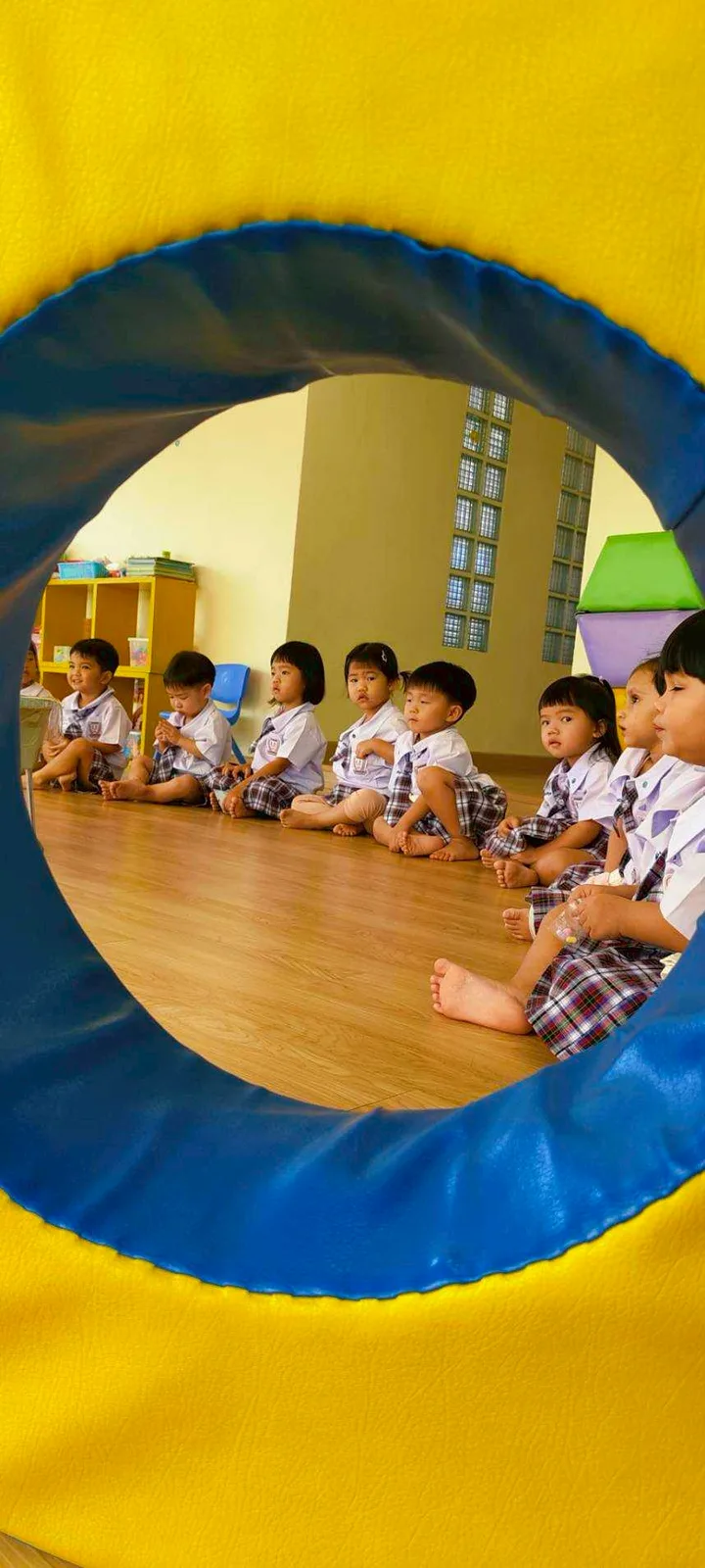Child crawling through a soft sensory play tunnel