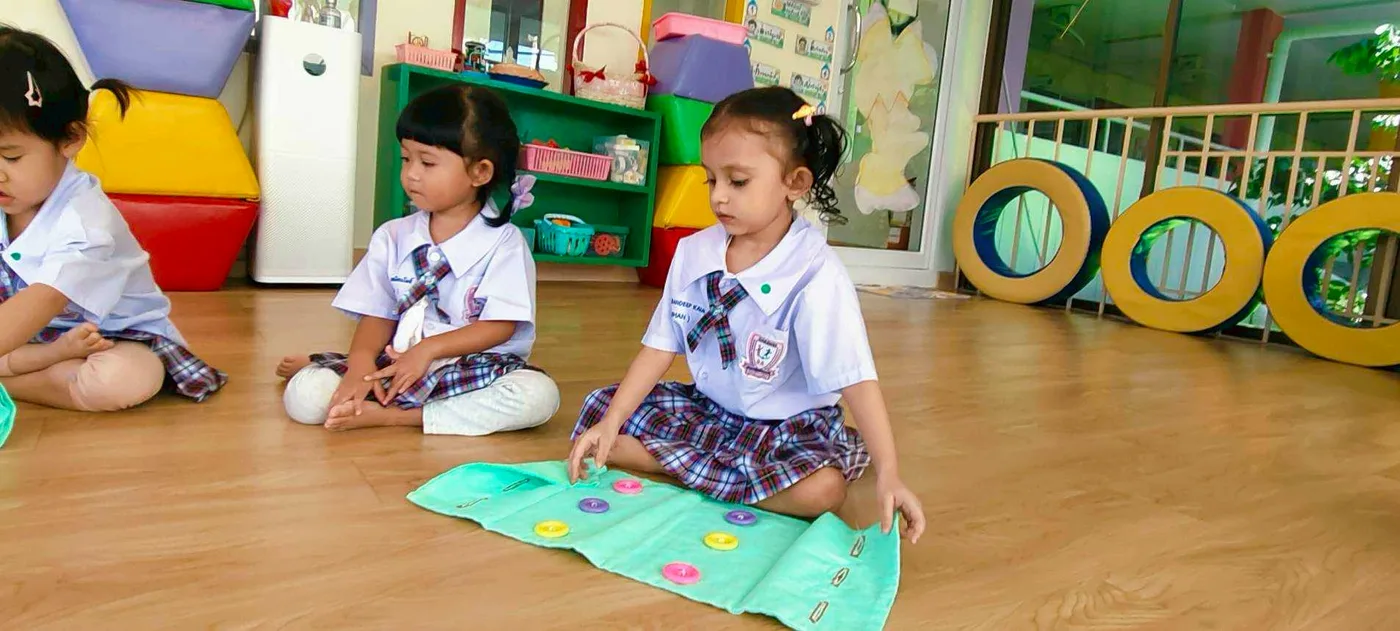 Two children working together on a hands-on Montessori activity
